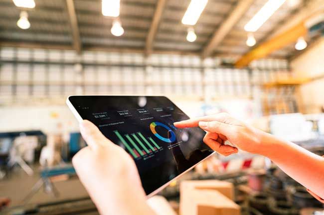 A small business fleet owner is reviewing fleet card data on a tablet.